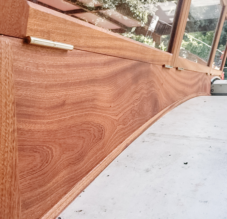 close up of the front of a wheelhouse showing a red timber with swirling grain