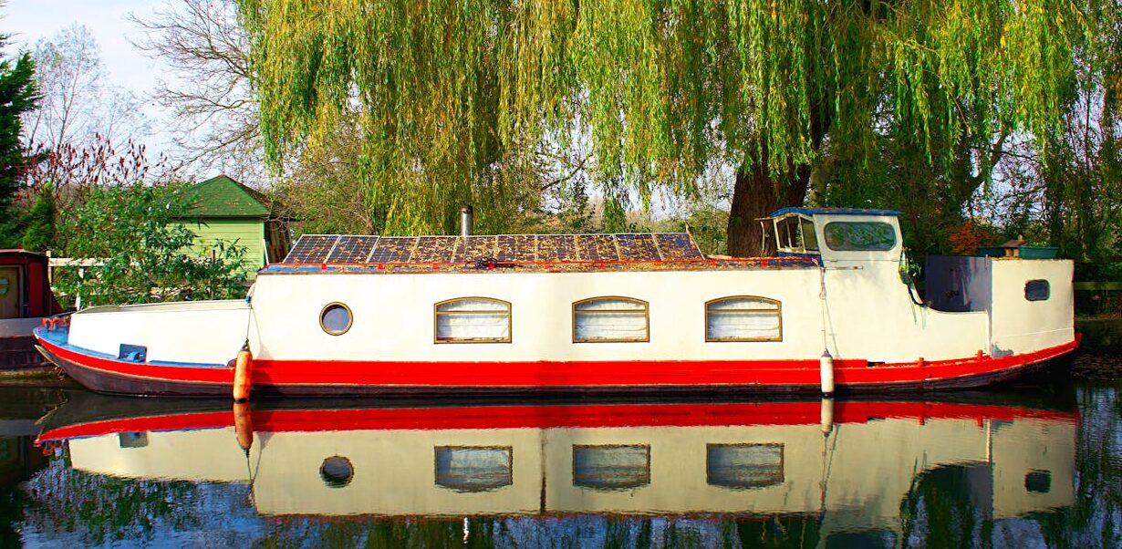 A Narrowboat docked on the side of the river