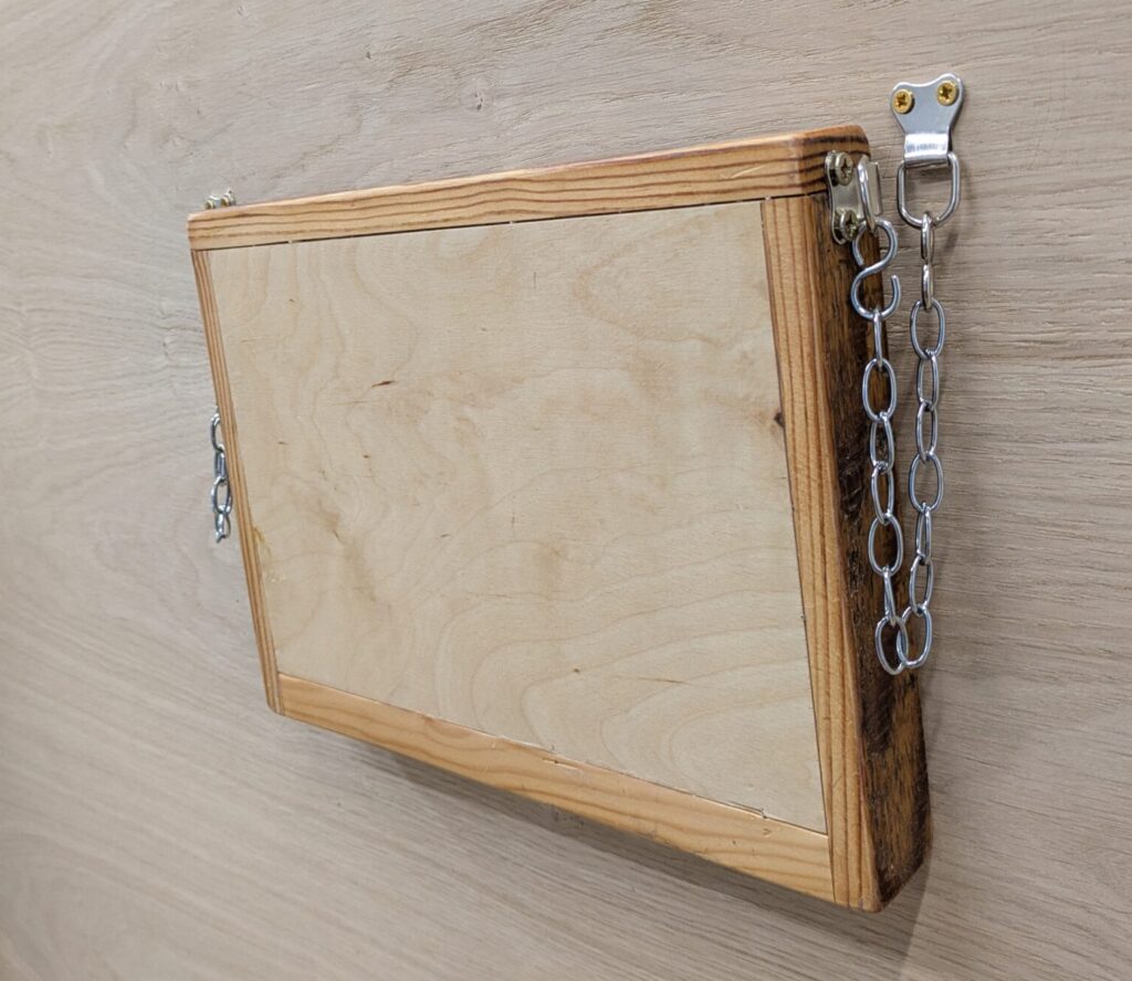 ShopShelvesFP Cluett Carpentry The Ellie Shelf for angled walls folded up with magnet to hold it in place